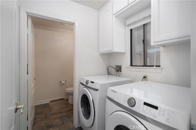 washroom featuring washing machine and dryer and cabinets