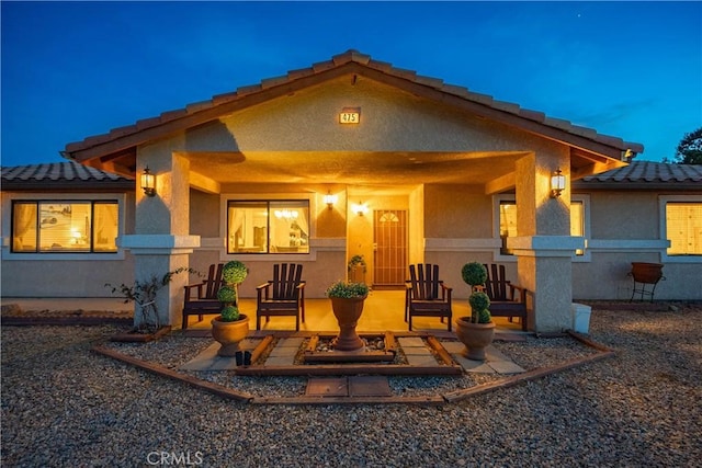 rear view of property featuring a patio