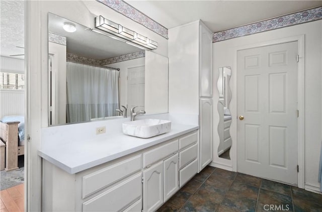 bathroom featuring vanity and curtained shower