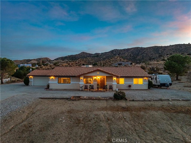 single story home featuring a mountain view and a garage