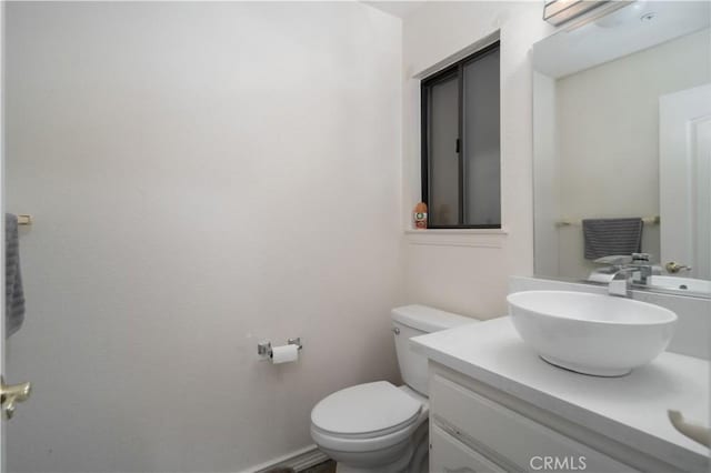 bathroom with toilet and vanity