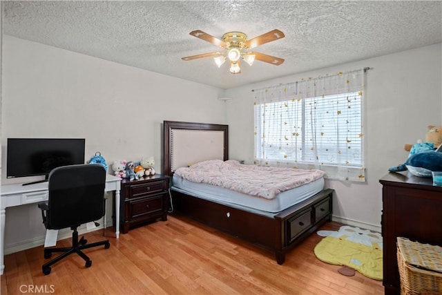 bedroom with ceiling fan, a textured ceiling, and light hardwood / wood-style floors