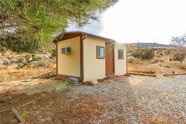 view of outdoor structure with a wall mounted air conditioner