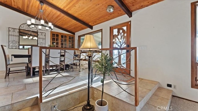 dining space featuring vaulted ceiling with beams, an inviting chandelier, and wooden ceiling