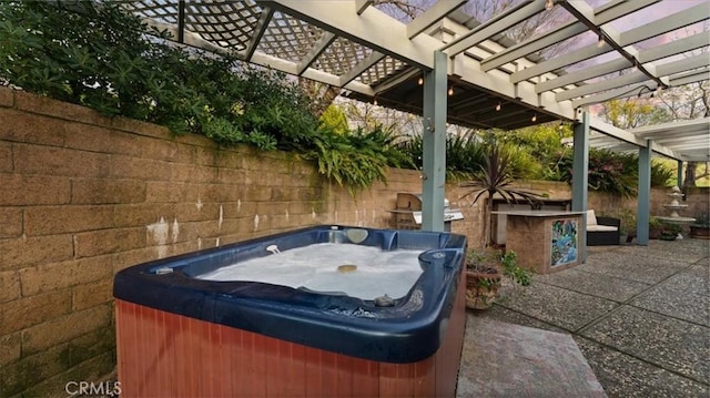 view of patio featuring a pergola and a hot tub