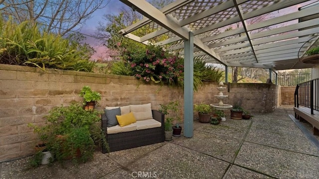 patio terrace at dusk with an outdoor hangout area and a pergola