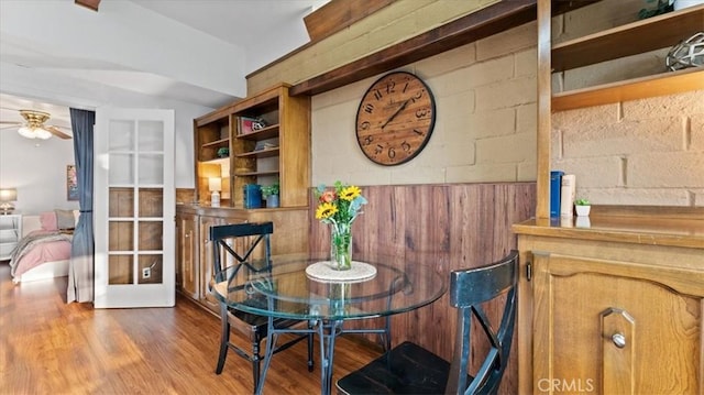 dining space with ceiling fan, french doors, and hardwood / wood-style flooring