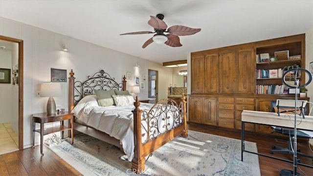 bedroom with ceiling fan and dark wood-type flooring