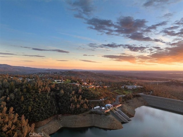 aerial view at dusk with a water view