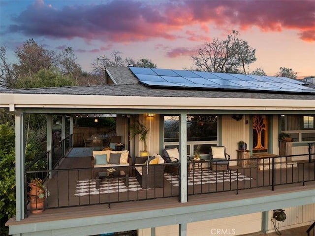 deck at dusk with outdoor lounge area