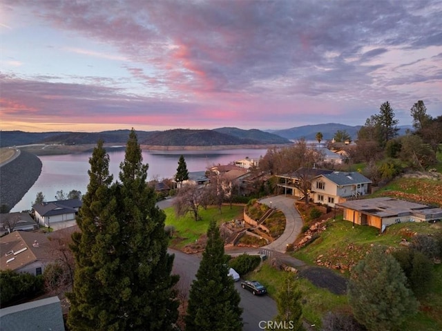 aerial view at dusk with a water and mountain view