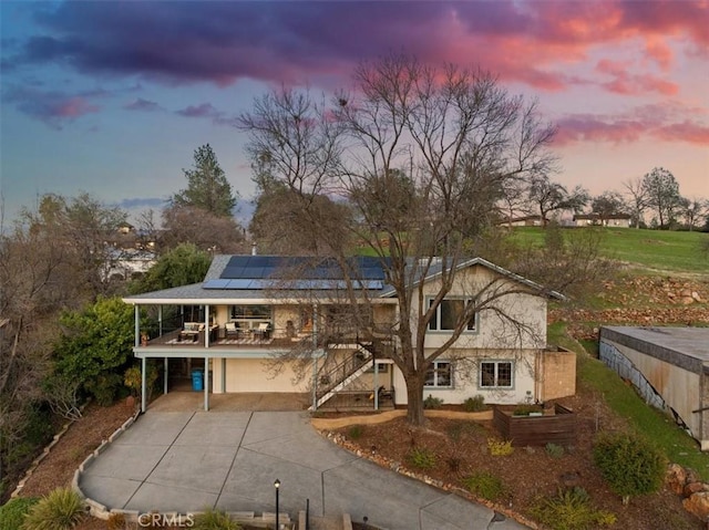 back house at dusk featuring a garage