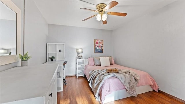 bedroom with ceiling fan and wood-type flooring