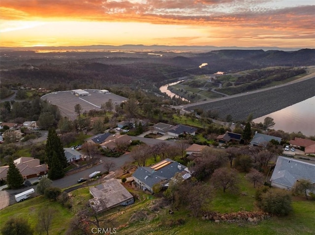 aerial view at dusk with a water and mountain view