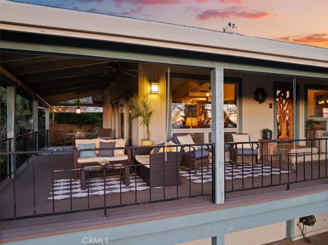 deck at dusk with an outdoor living space