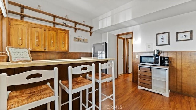 kitchen featuring stainless steel appliances and light hardwood / wood-style floors