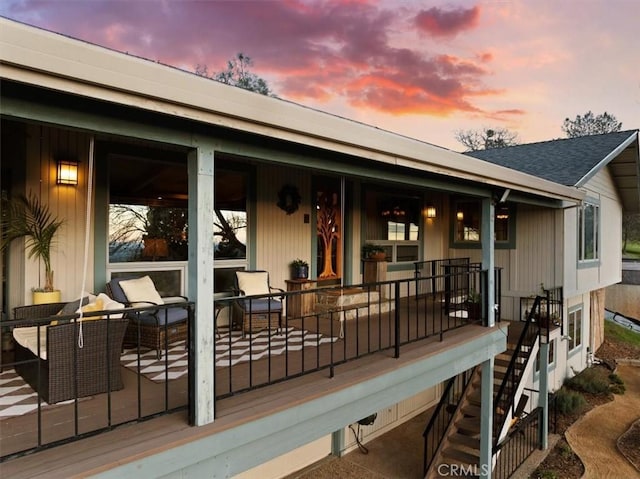 deck at dusk featuring an outdoor living space