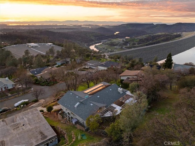 aerial view at dusk featuring a mountain view