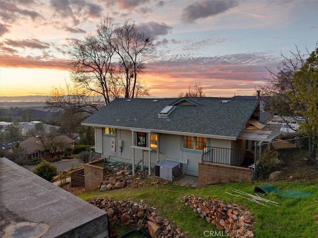 view of back house at dusk