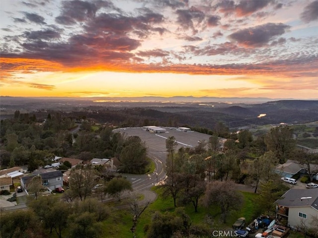 aerial view at dusk featuring a mountain view