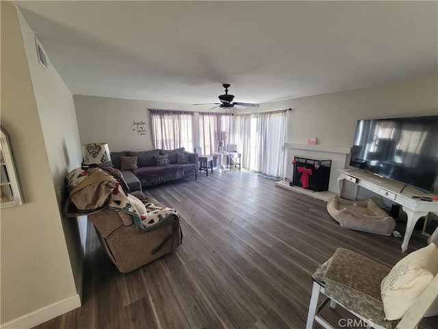 living room with dark hardwood / wood-style floors and ceiling fan