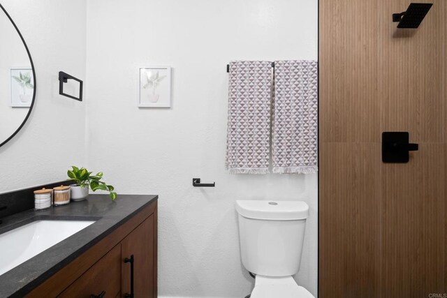 bathroom featuring toilet and vanity