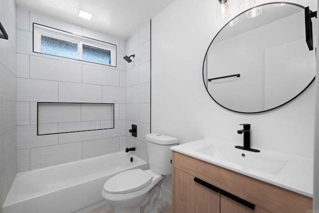 full bathroom featuring toilet, tiled shower / bath, and vanity