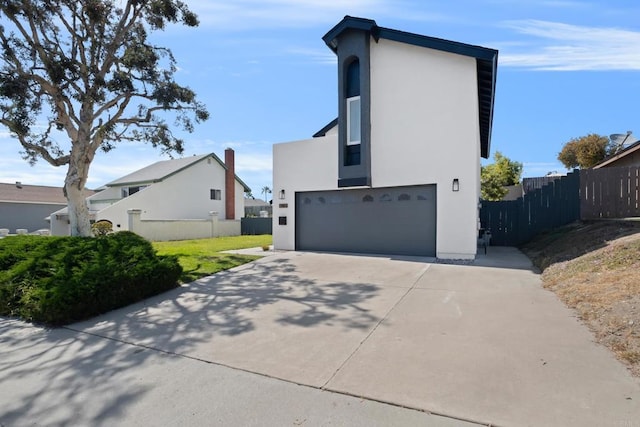 view of side of property featuring a garage and a lawn