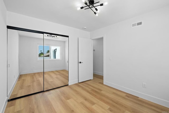 unfurnished bedroom featuring hardwood / wood-style flooring and a closet