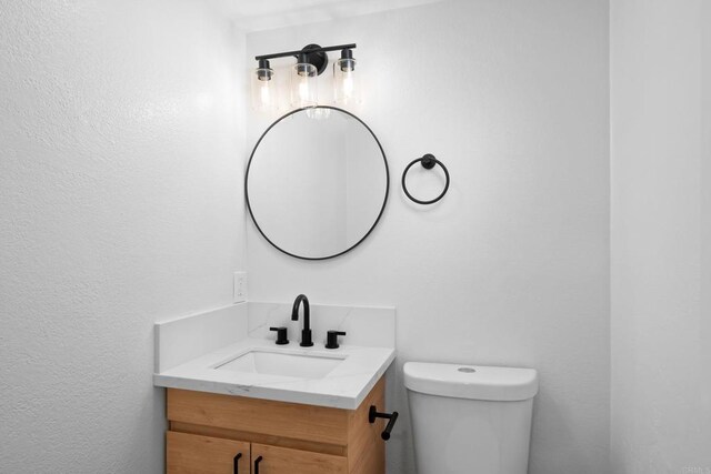 bathroom featuring toilet and vanity