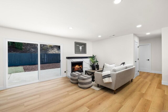 living room with a fireplace and light hardwood / wood-style floors