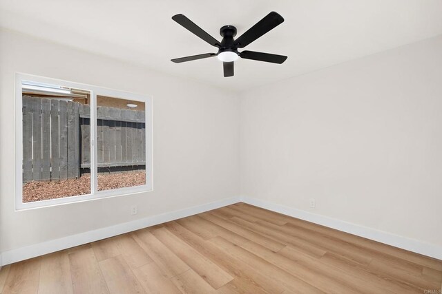 spare room featuring hardwood / wood-style floors and ceiling fan