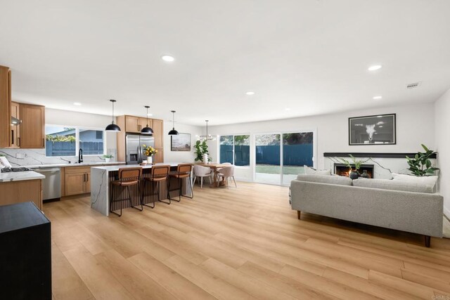 living room featuring sink and light wood-type flooring