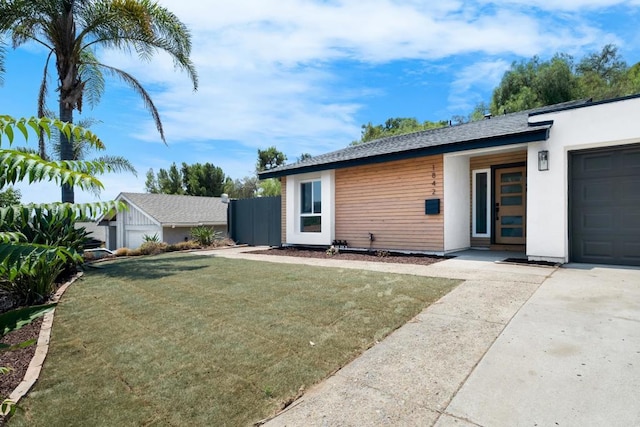 back of house featuring a lawn and a garage