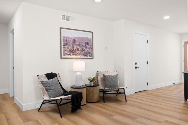 sitting room featuring light hardwood / wood-style flooring