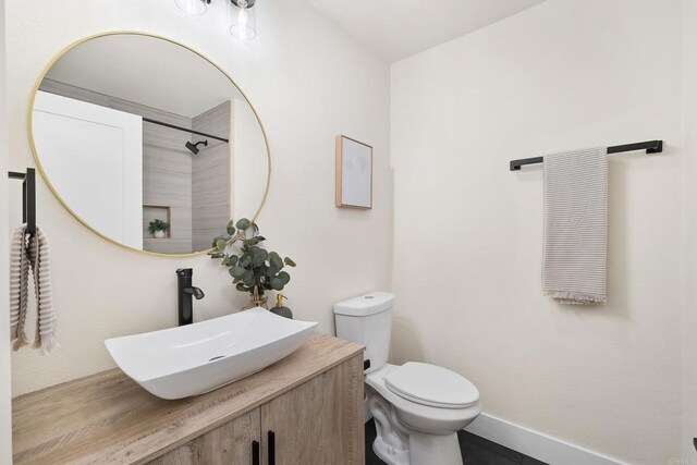 bathroom featuring toilet and vanity