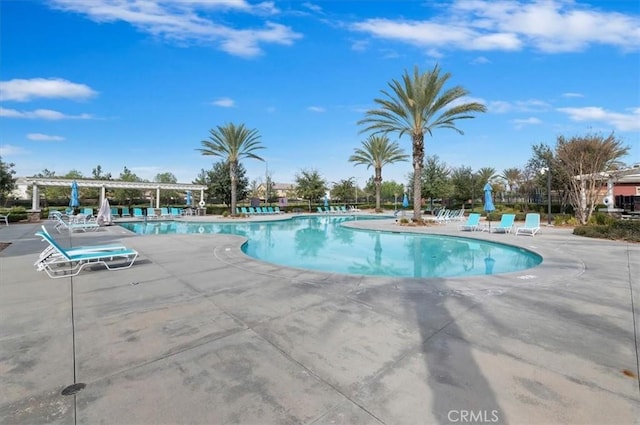 pool featuring a pergola and a patio area