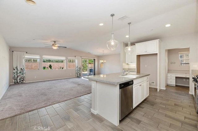 kitchen featuring open floor plan, a kitchen island with sink, stainless steel dishwasher, and white cabinetry