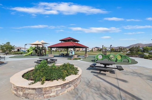 view of home's community featuring playground community, a mountain view, and a gazebo