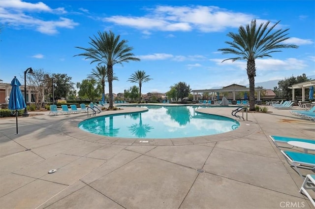 pool with a pergola and a patio