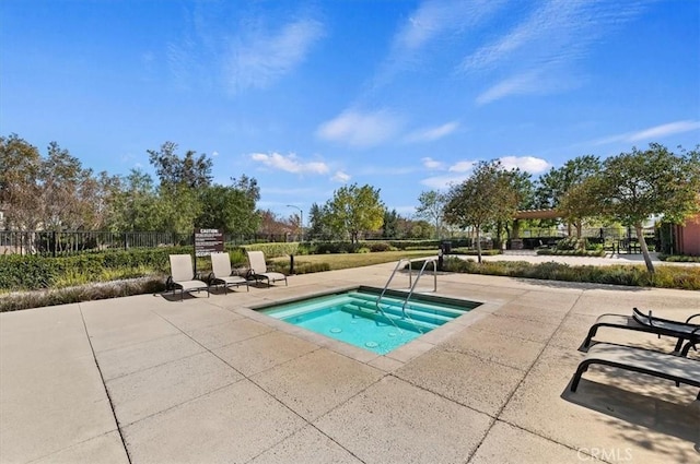 view of pool with a patio, a hot tub, and fence