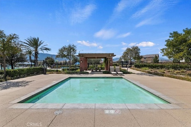 outdoor pool with a patio area and fence