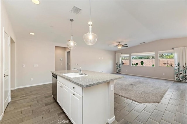 kitchen with visible vents, wood finish floors, a sink, vaulted ceiling, and dishwasher