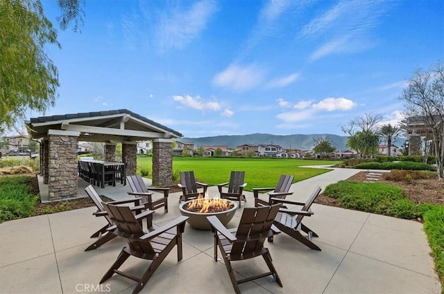 view of patio featuring a gazebo, a mountain view, and a fire pit