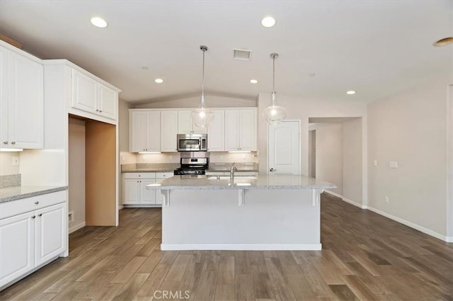 kitchen featuring wood finished floors, visible vents, a sink, white cabinets, and appliances with stainless steel finishes