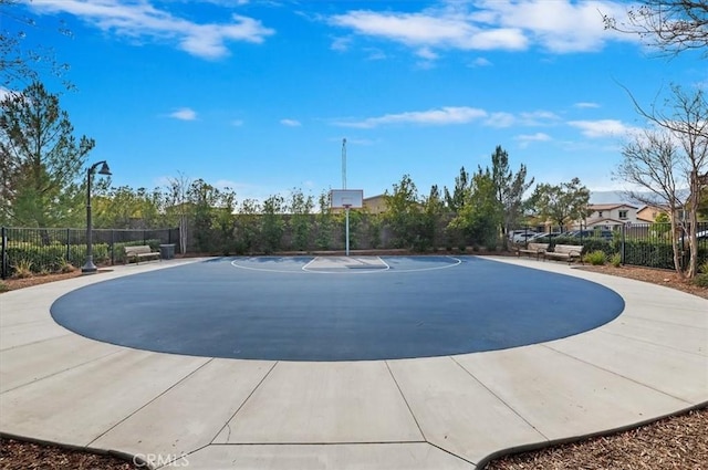 view of basketball court with community basketball court and fence