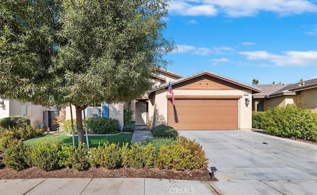 view of front facade featuring driveway, a garage, and stucco siding