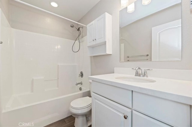 bathroom featuring toilet, vanity, bathtub / shower combination, and wood finished floors