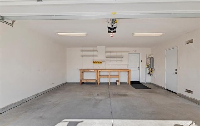 garage with a garage door opener and baseboards