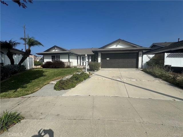 ranch-style home with a front yard and a garage